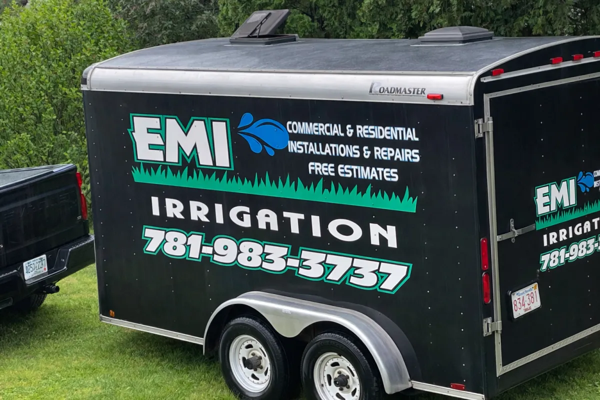 EMI Irrigation branded work trailer on a residential property
