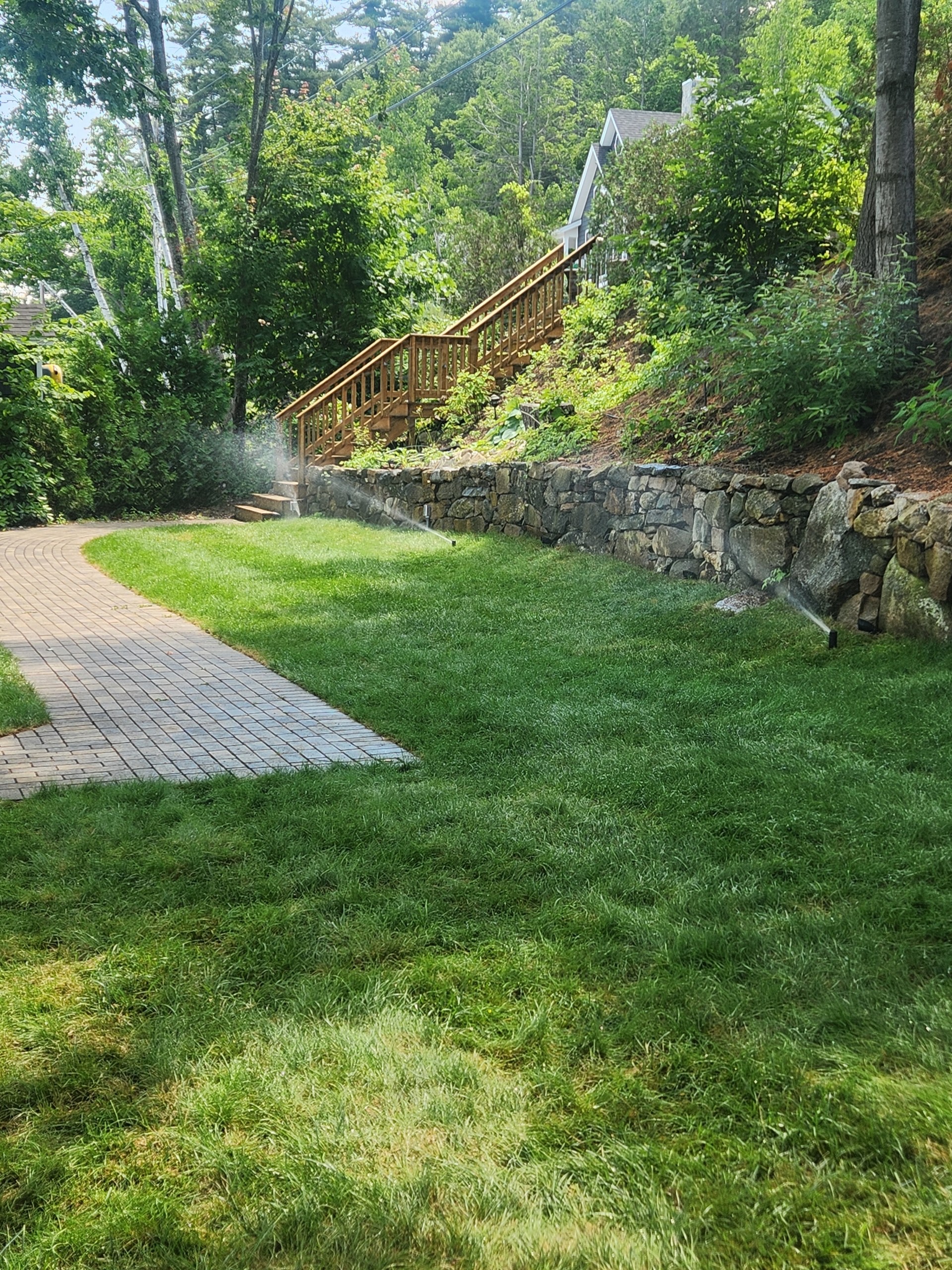 Sprinkler system watering a lush green lawn